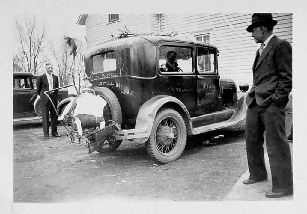 Peter Espe and Oscar Dahlgren view Omer and Myrtle Espe's wedding vehicle